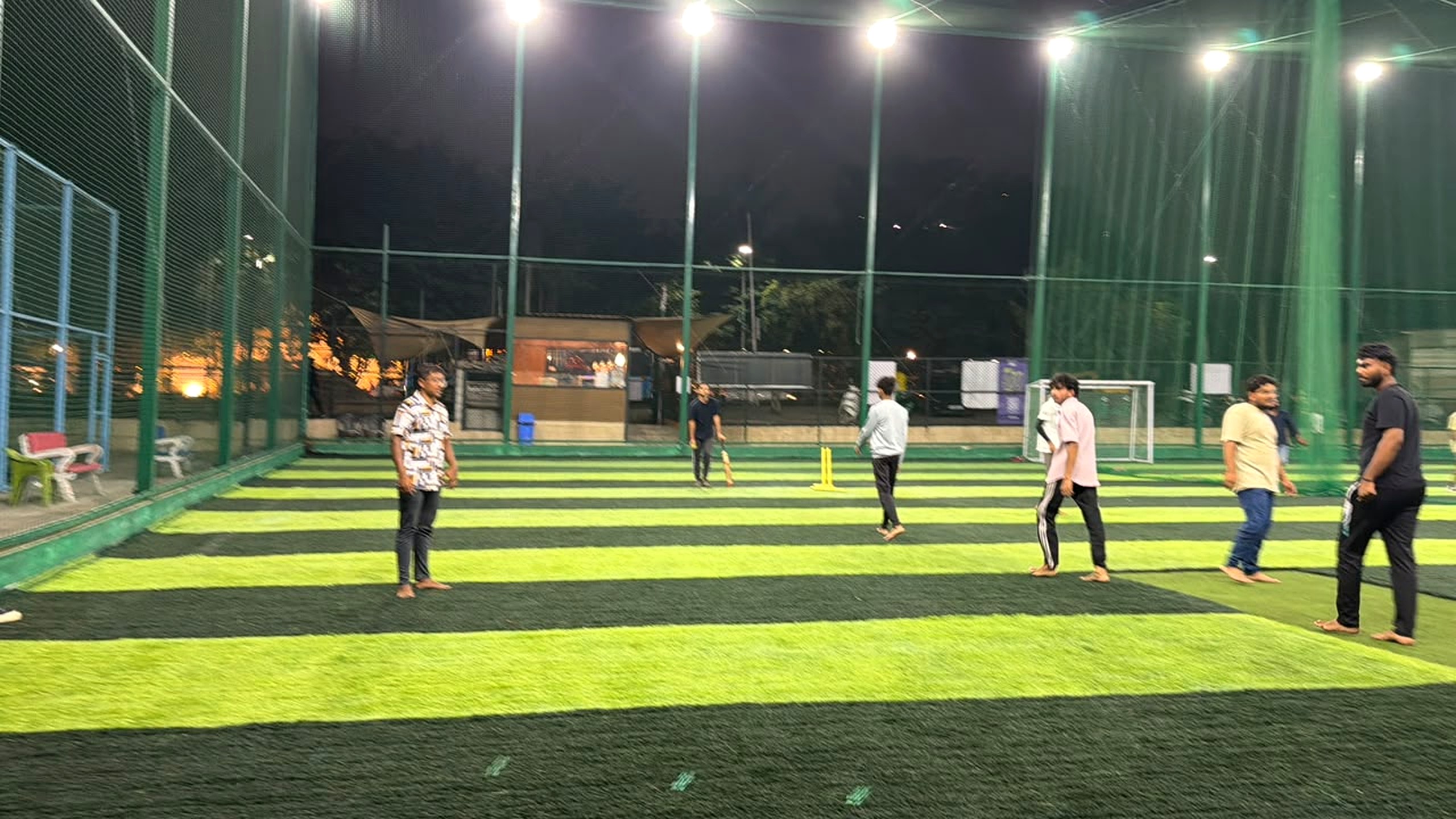 Players on the floodlit turf at Urbanpitch Sports Academy during the Hostel Premiere League trial run
